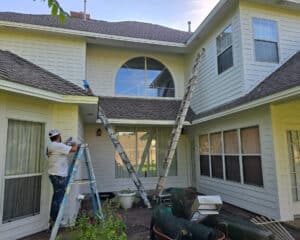 Painter working on exterior of Texas home