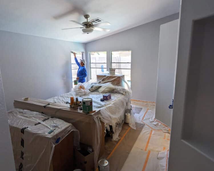 Painter painting interior walls grey
